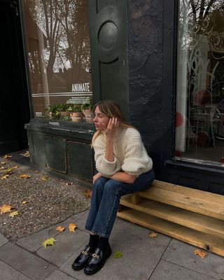 Lizzy Hadfield in jeans and beige jumper