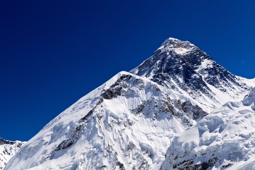 The summit of Everest with a dark blue sky