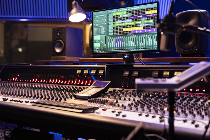 Control desk in professional music studio with motorized faders and knobs