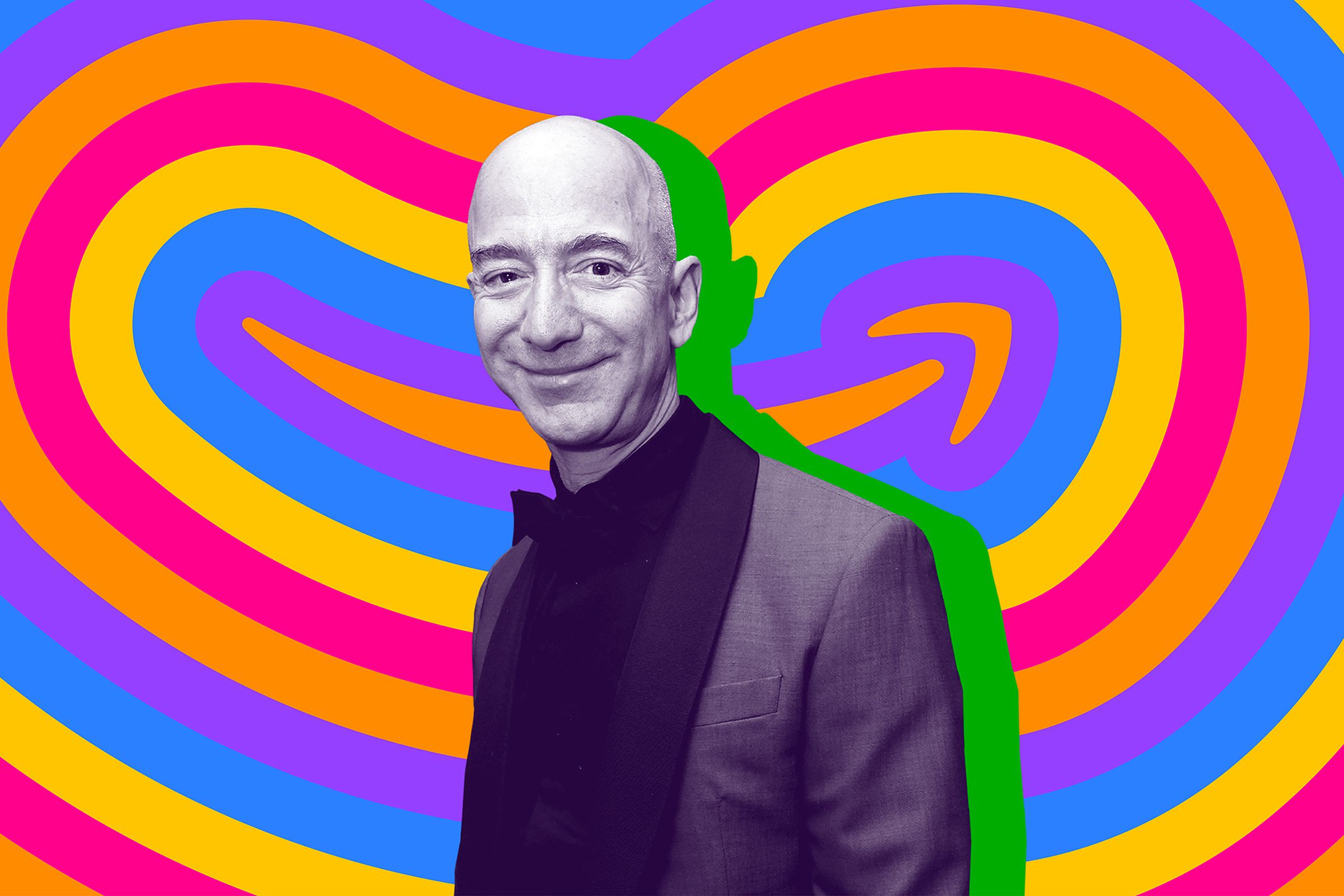 Jeff Bezos stands in front of an Amazon logo