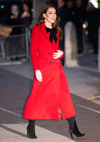 Kate Middleton wears a black bow and a red coat to a Christmas event in December 2024