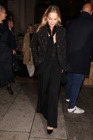 Kate Moss in black blazer, trousers and scarf