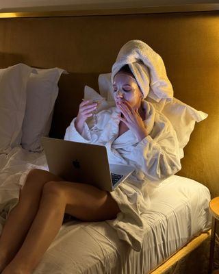 Content creator Emma Leger drinks a martini while wearing a face mask in Paris, France