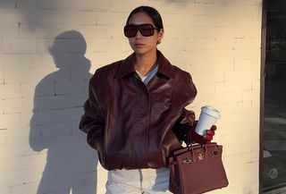 Aimee Song in a burgundy leather bomber jacket and matching Hermés bag.