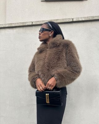 Influencer wears faux fur.