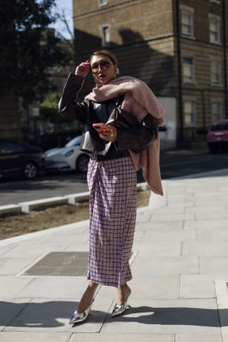 Woman attending London Fashion Week wearing silver shoes.