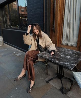 Influencer wears brown satin trousers