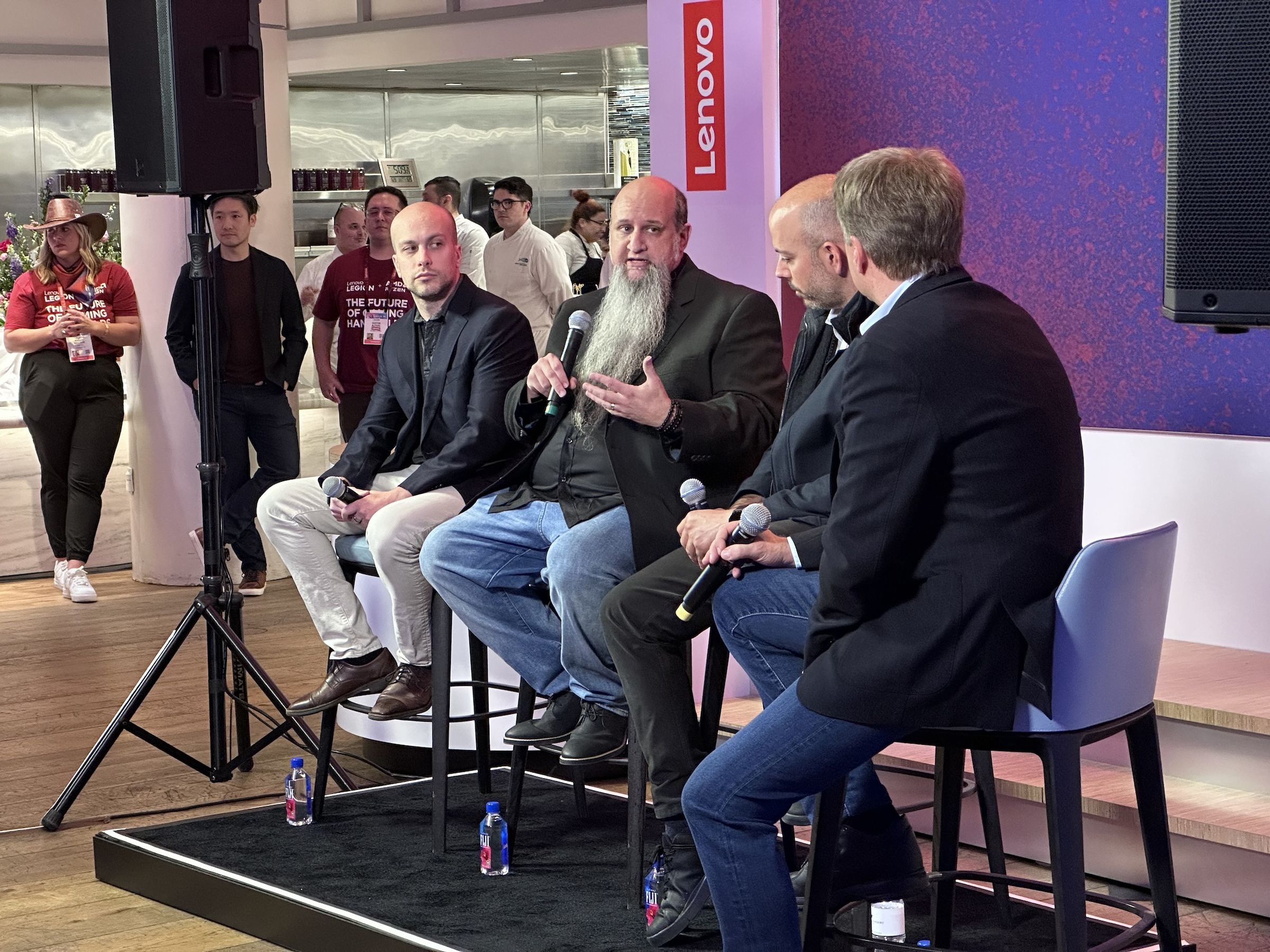 Microsoft’s Jason Ronald speaks at the Lenovo/AMD event, flanked by Valve SteamOS designer Pierre-Loup Griffais (left) and AMD chief gaming architect Frank Azor (middle right).