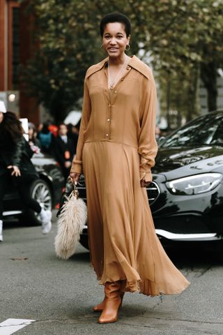 Fashion week boho street style outfit with light brown leather knee boots