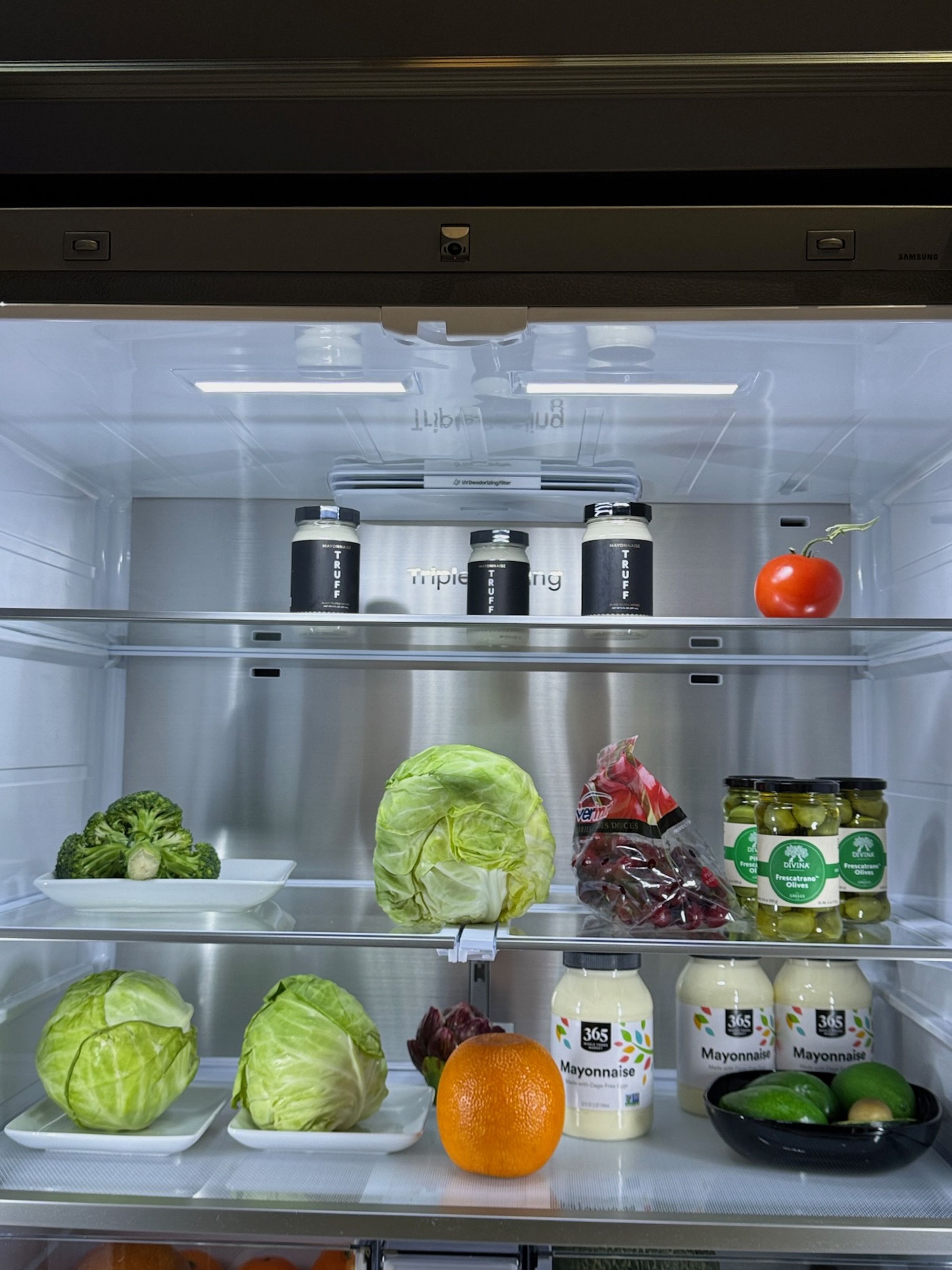 A new camera above the door in Samsung’s smart fridges uses on-board AI to identify up to 37 food items as you put them in or take them out of the fridge. 