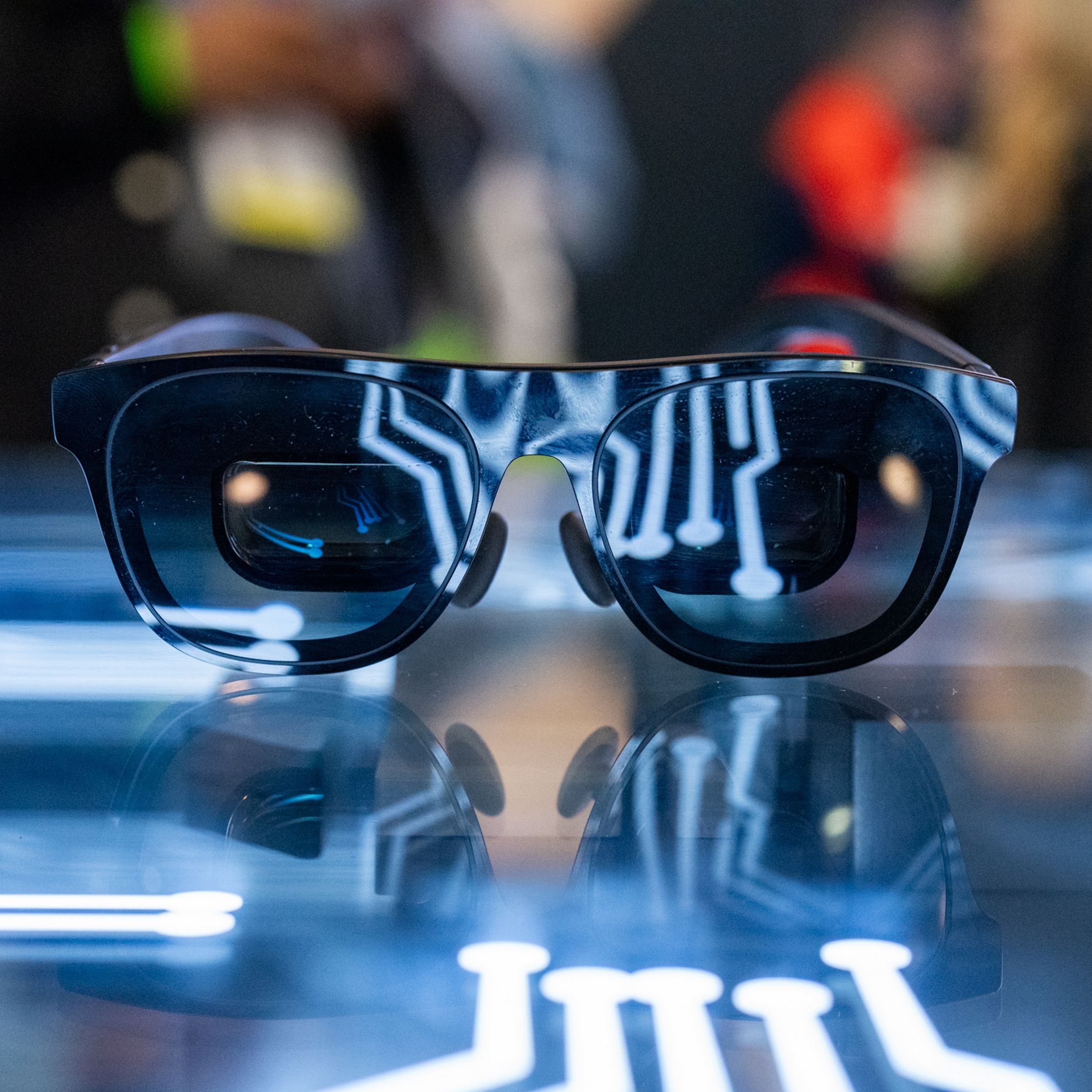 Pair of XREAL smart glasses lit up in a futuristic way.