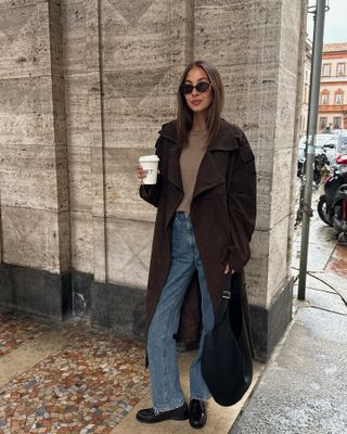 Felicia Akerstrom in a brown suede coat and Saint Laurent loafers.