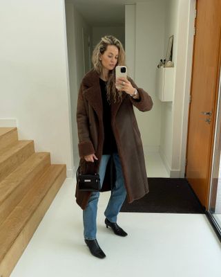 Anouk Yve in a brown shearling Arma Coat.