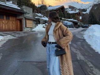 Emma Rose Leger in a faux fur coat in the Swiss Alps.