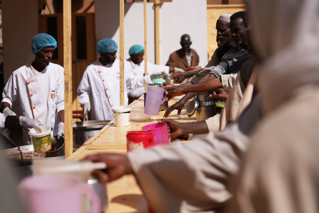 Civilians fleeing conflict in Sudan access hot meals in places called "lodge"